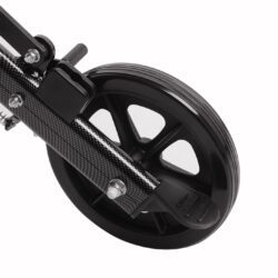 Close-up of a black wheelchair wheel with a carbon fiber frame.