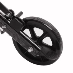 Close-up of a black wheelchair wheel with a carbon fiber frame.