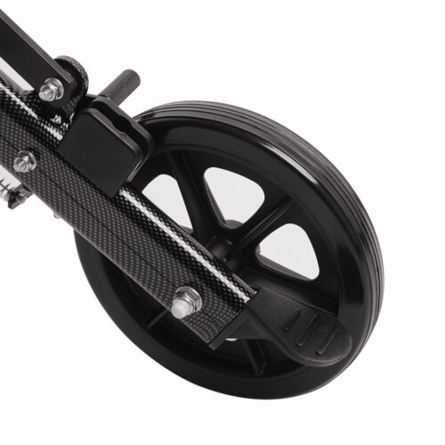 Close-up of a black wheelchair wheel with a carbon fiber frame.