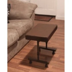 Brown adjustable leg rest stool beside a beige sofa on wooden flooring.