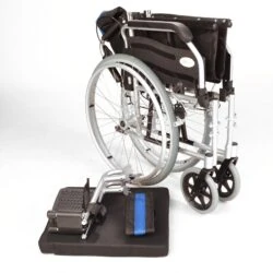 Folded lightweight wheelchair with detached leg rests and cushion.
