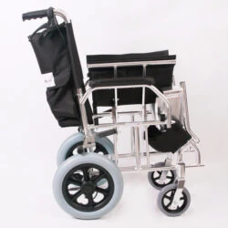 Side view of a compact travel wheelchair with black seat and silver frame.