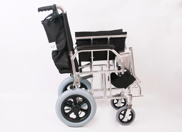 Side view of a compact travel wheelchair with black seat and silver frame.