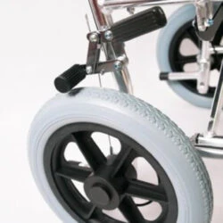 Close-up of a wheelchair's rear wheel and brake mechanism.