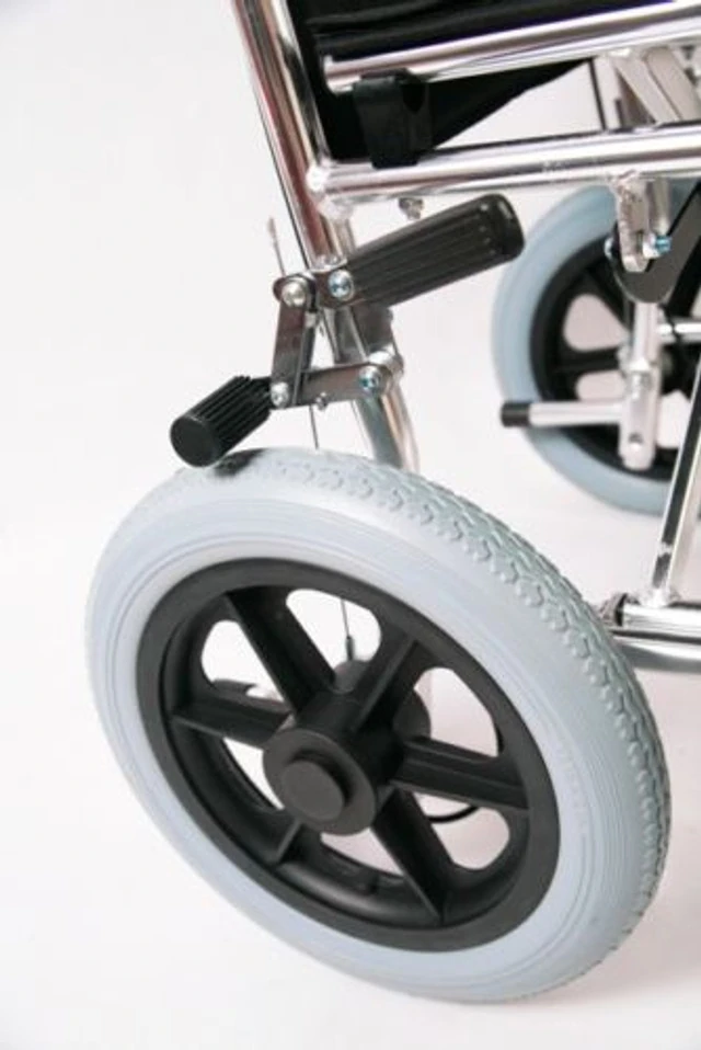 Close-up of a wheelchair's rear wheel and brake mechanism.