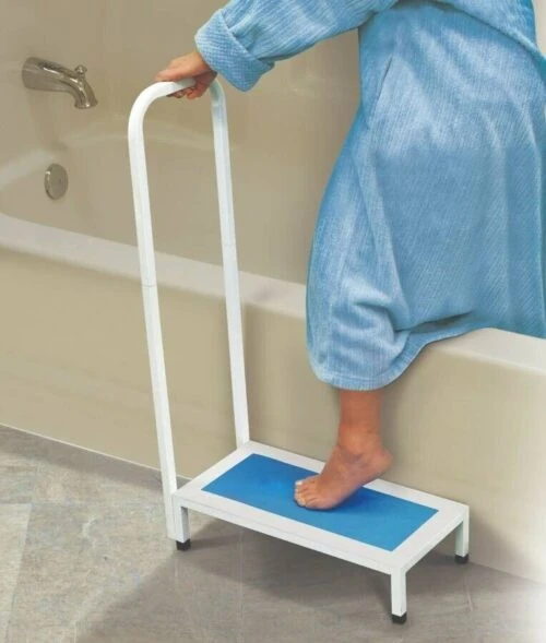 Person using a non-slip bath step with handle next to a bathtub.