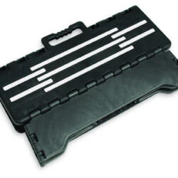 Folded black step stool with handle and striped design.