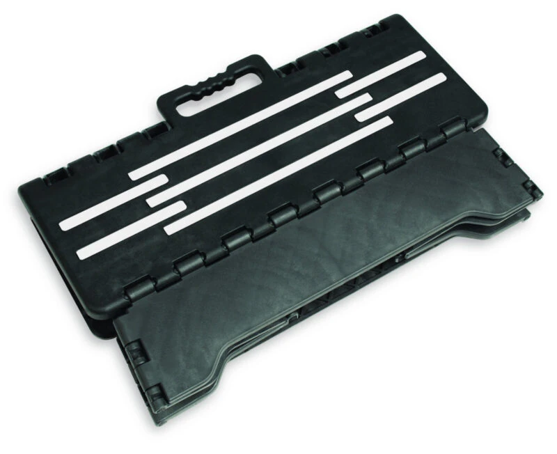 Folded black step stool with handle and striped design.