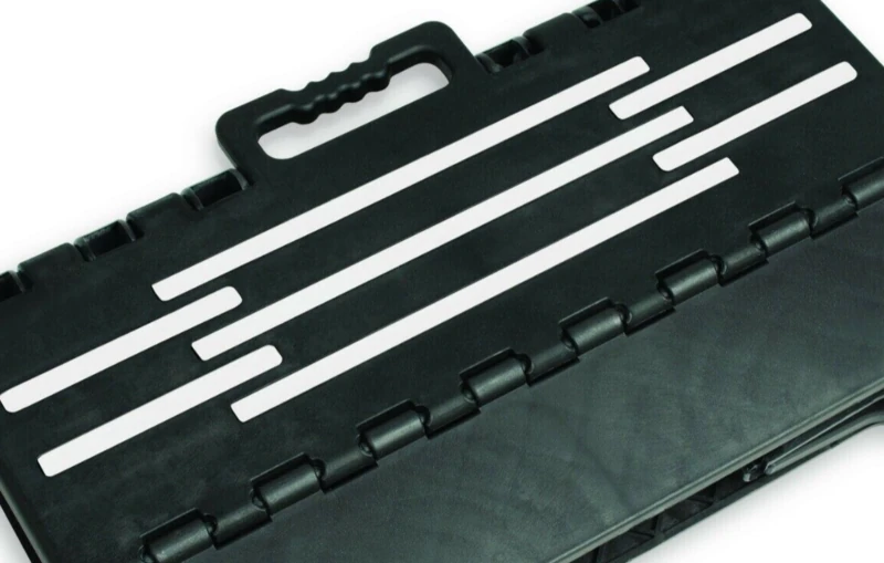 Black folding step stool with a handle and white non-slip strips.