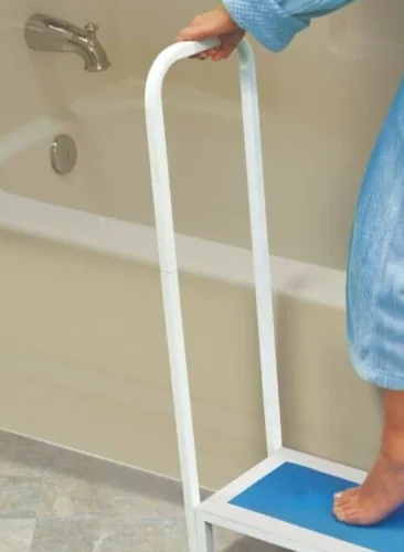 Person using a non-slip bath step with a handle next to a bathtub.