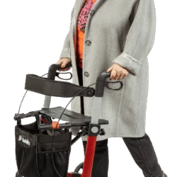 Person using a red Mobilex Leopard rollator with a shopping bag.