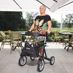 Person using Mobilex Lion rollator with large wheels on a patio.