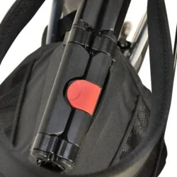 Close-up of folded rollator with red locking mechanism.