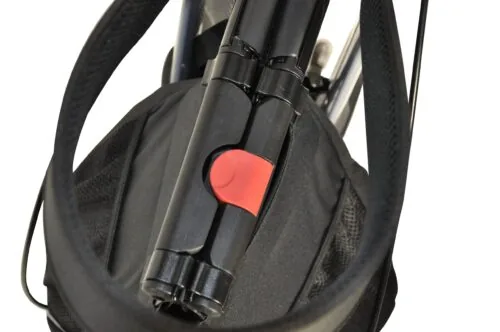 Close-up of folded rollator with red locking mechanism.