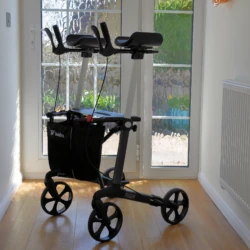 Tiger Indoor Rollator with armrests and shopping bag in a sunlit room.