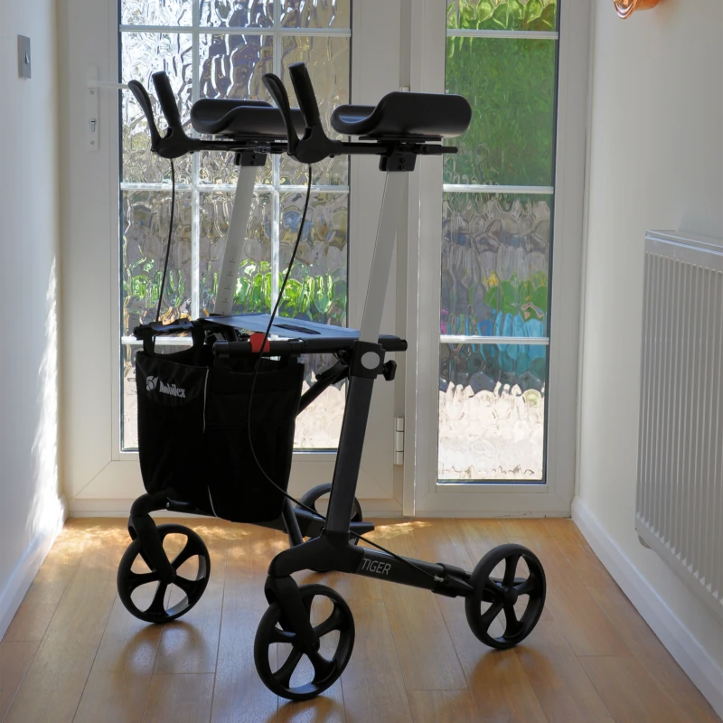 Tiger Indoor Rollator with armrests and shopping bag in a sunlit room.