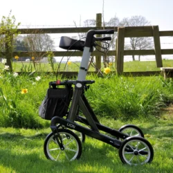 Mobilex Lion rollator with large wheels on grass near a wooden fence.