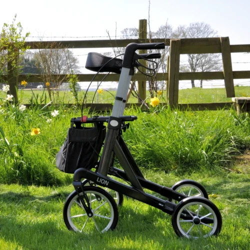 Mobilex Lion rollator with large wheels on grass near a wooden fence.