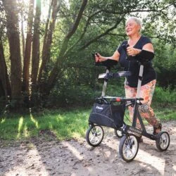 Person using Mobilex Tiger Outdoor Rollator on a forest path.
