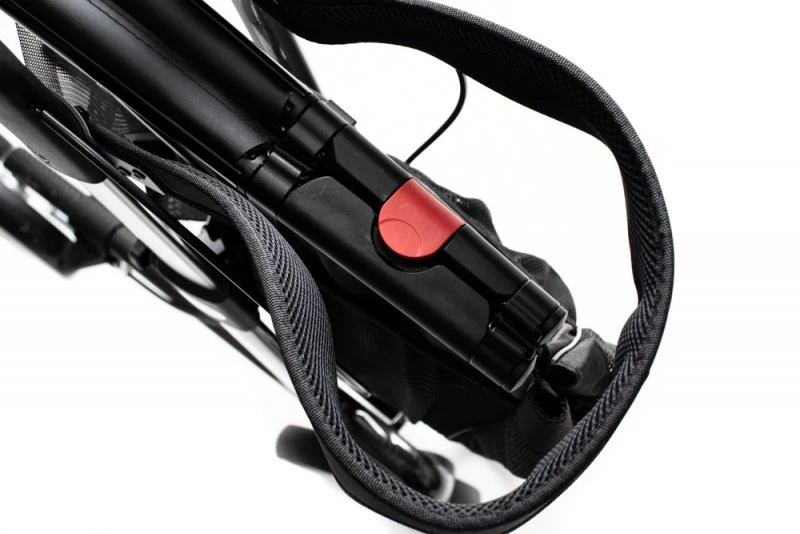 Close-up of folded Carbon Ultralight Rollator with red latch.