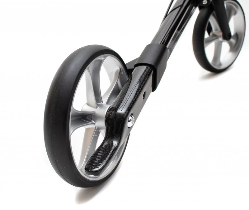Close-up view of a carbon fiber rollator wheel with a sleek design.