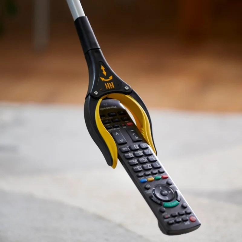 Arthri-Grip PRO Reacher holding a TV remote control.
