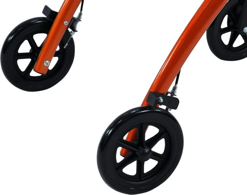 Close-up view of the wheels on an orange indoor rollator.