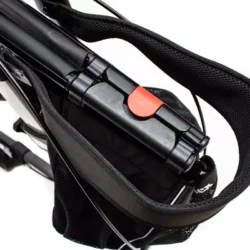 Top view of folded rollator with black bag and red latch.