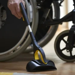 Small grabber tool being used near a wheelchair.