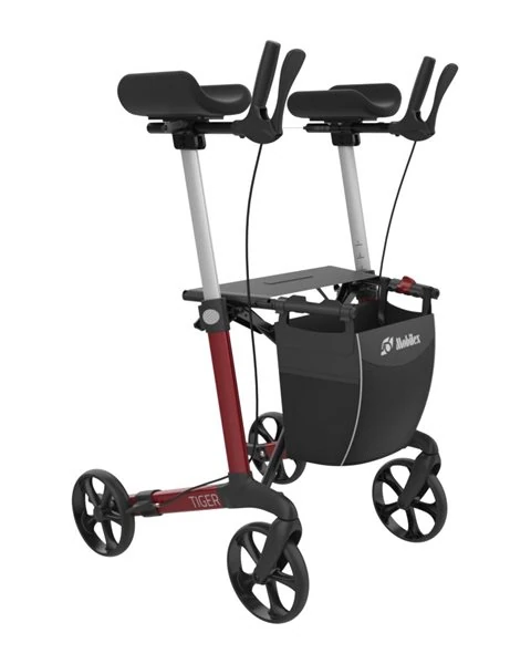 Red upright rollator with armrests and a black shopping bag.