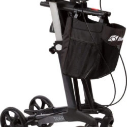 Folded upright rollator with armrests and a black shopping bag.