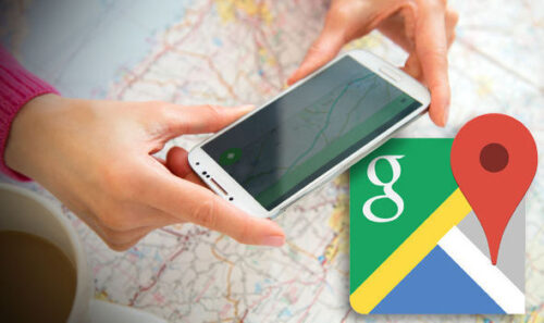 Person using a smartphone with a map and Google Maps logo.