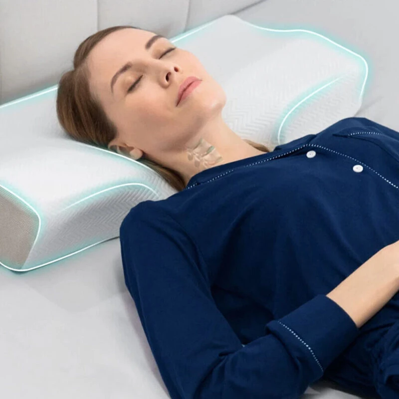 Person resting on a contoured memory foam pillow designed for neck support.