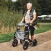 Person using the Mobilex Puma Air rollator on a gravel path.