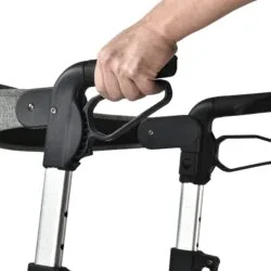 Close-up of a hand adjusting the handle on a rollator.