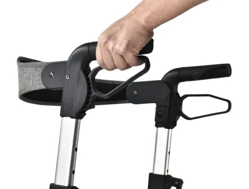 Close-up of a hand adjusting the handle on a rollator.