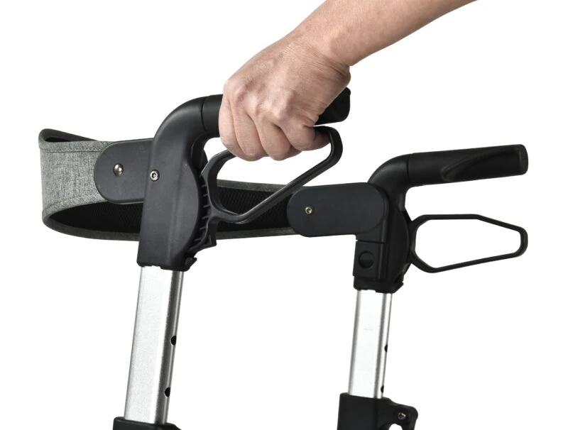 Close-up of a hand adjusting the handle on a rollator.