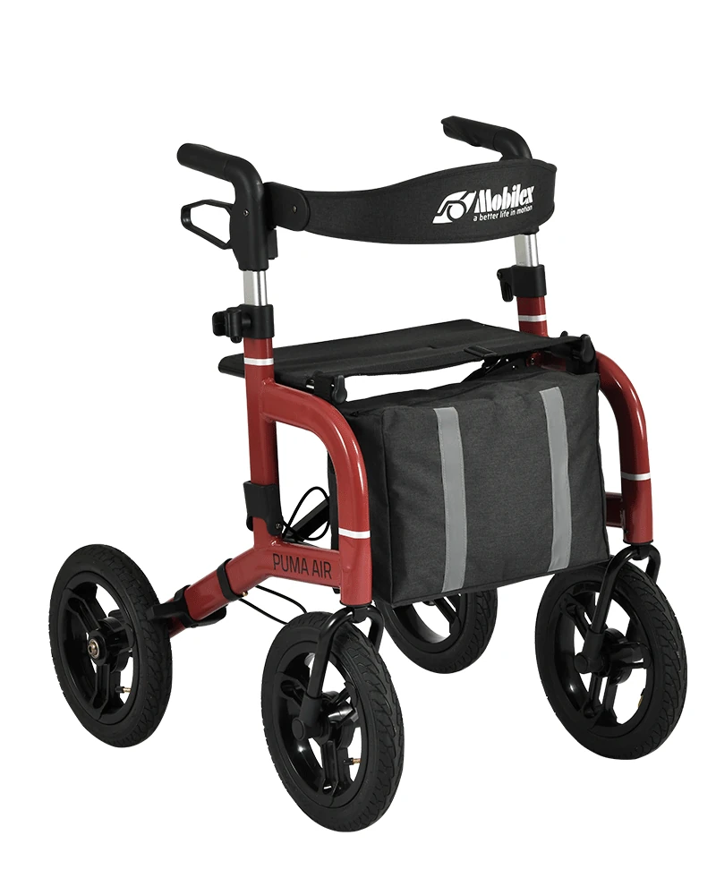 Red rollator with large black wheels and a storage bag.