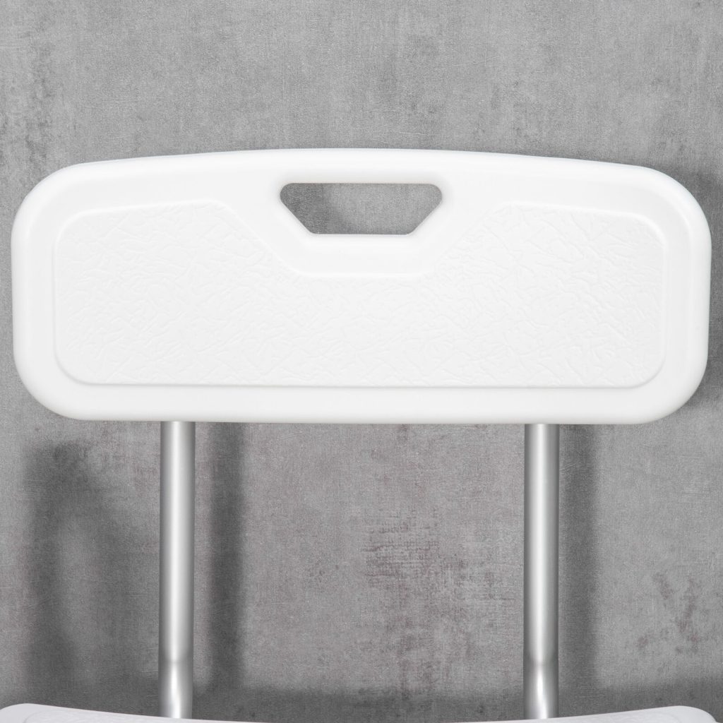 Close-up of the white backrest of a shower chair with a handle.
