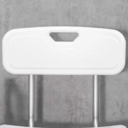 Close-up of the white backrest of a shower chair with a handle.
