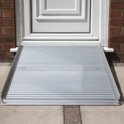Aluminium rollable ramp placed at a doorstep for accessibility.