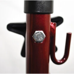 Close-up of a red metal frame with a bolt on a tri walker.