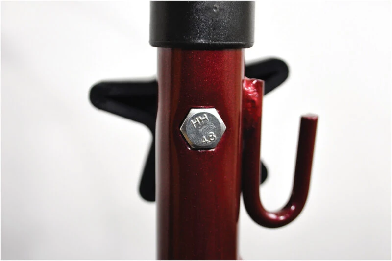 Close-up of a red metal frame with a bolt on a tri walker.