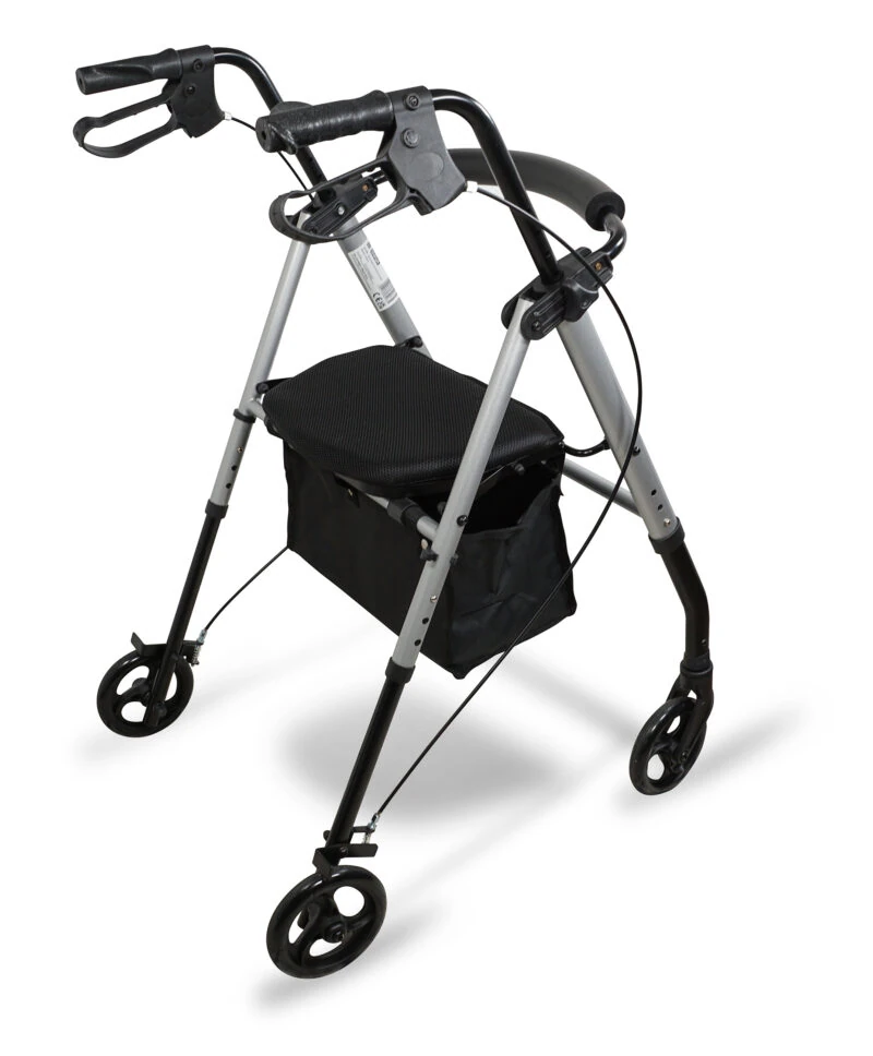 Silver rollator with four wheels, padded seat, and under-seat storage.