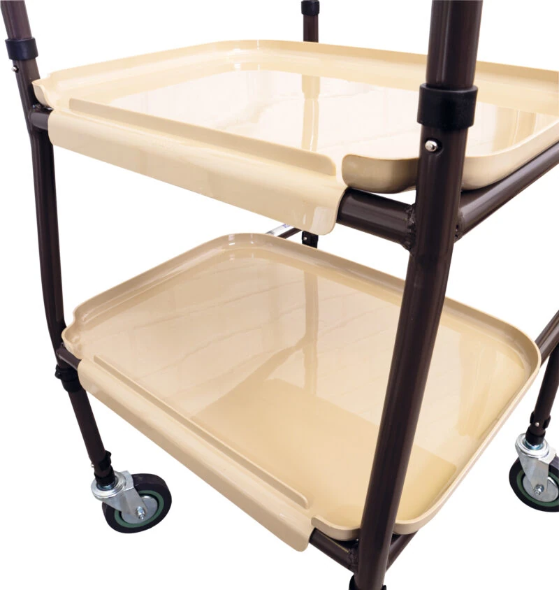 Close-up of a two-tier beige trolley with wheels and tubular steel frame.