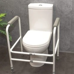 White adjustable toilet support frame around a toilet.