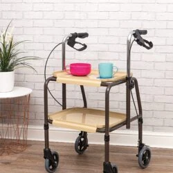 Indoor trolley with brakes, two trays, and a pink bowl and blue mug on top.