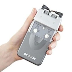 Hand holding a gray TENS machine with dials and labeled MED-FIT 1.