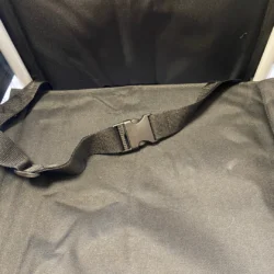 Close-up of a wheelchair seat showing a secure lap belt.