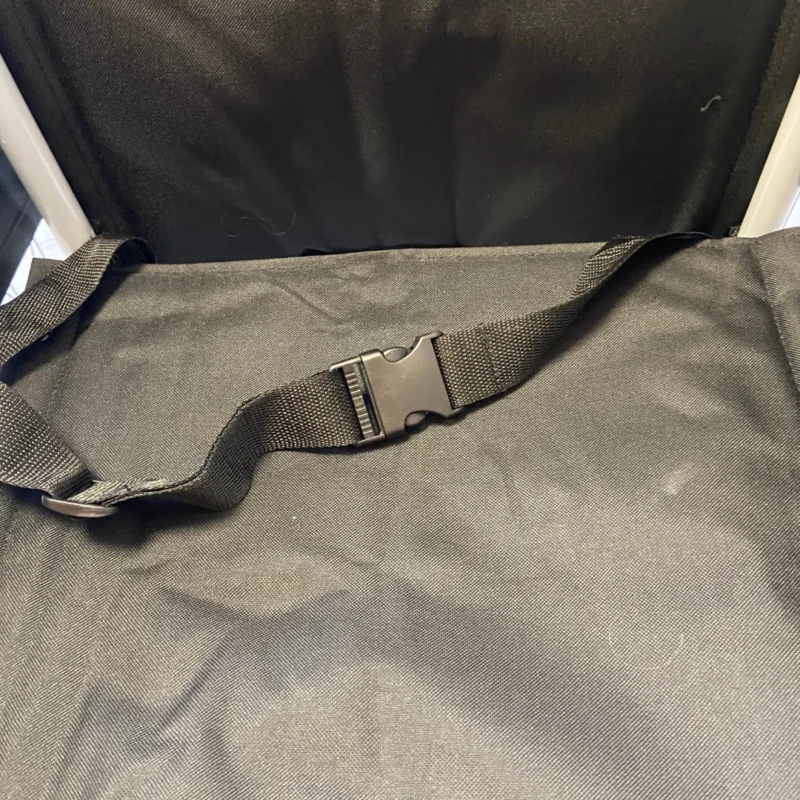 Close-up of a wheelchair seat showing a secure lap belt.